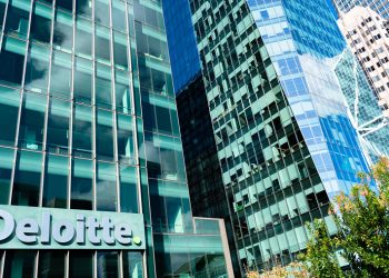 Deloitte logo is seen on company headquarters.