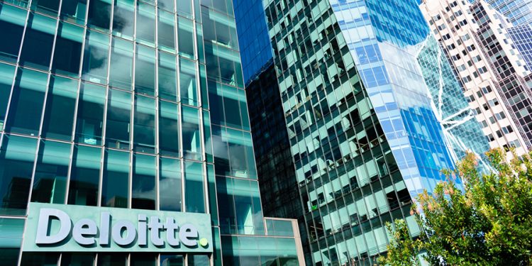 Deloitte logo is seen on company headquarters.